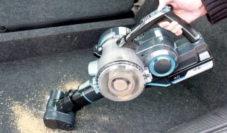 Cordless vacuum cleaner cleaning up dirt